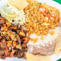 Platillo De Steak Picado · Tender chopped steak grilled with pico de gallo. Served with rice, refried beans, guacamole ...
