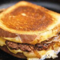Patty Melt Sandwich · Fresh burger patty on toasted rye bread with melted American cheese and grilled onions.