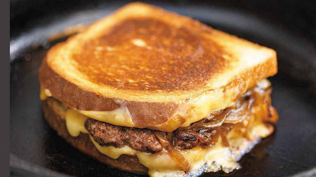 Patty Melt Sandwich · Fresh burger patty on toasted rye bread with melted American cheese and grilled onions.