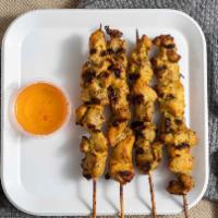 Gai Satay (Chicken Satay) · Four chicken skewers marinated in coconut sauce, grilled and served with peanut sauce.