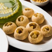 Pani Poori · Crisp puffed pastries filled with potatoes, chickpeas, spicy mint water & tangy sweet sauce.