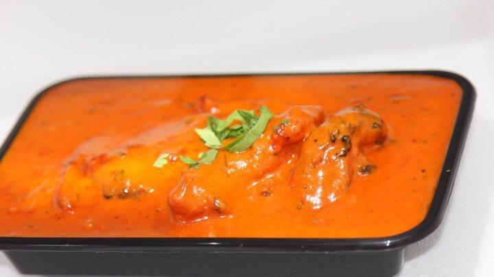 Chicken Tikka Masala · Clay oven roasted boneless chicken breast cubes cooked in a creamy sauce with herbs and spices.