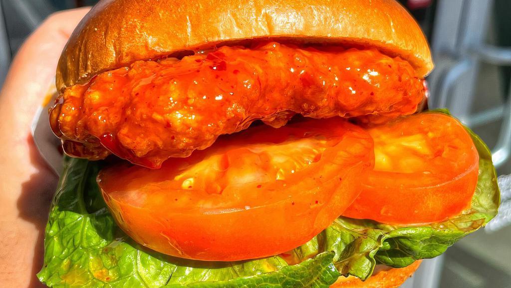 Double Breaded Chicken Sandwich · Hand breaded TWICE natural chicken breast tossed in your choice of sauce layered with fresh lettuce, tomatoes, pickles and our signature special sauce all packed in a toasted brioche bun. Make it a combo that includes fries and a bottled water.