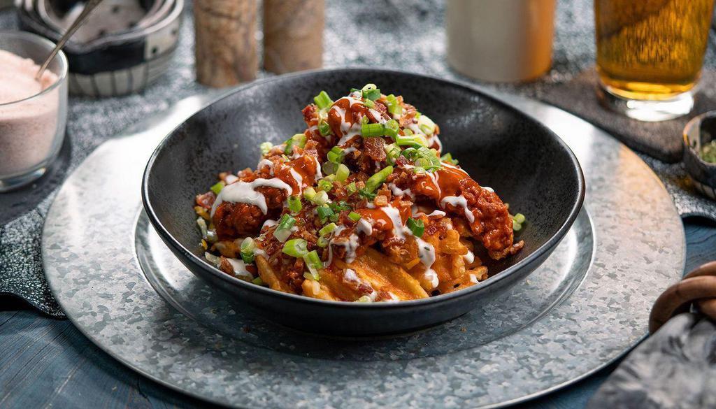 Bffl Frd Chckn Wffl Frs · waffle fries topped with jack cheese, fried chopped buffalo chicken, bacon, scallions + ranch.