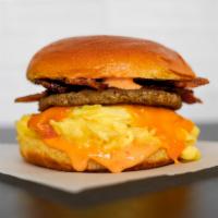 Brioche, Bacon, Sausage, Egg, & Cheddar Sandwich · 2 scrambled eggs, melted Cheddar cheese, smoked bacon, breakfast sausage, and Sriracha aioli...