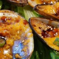 Baked Mussels On · Marinated spicy baked mussels. (Half Dozen).