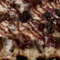 Filet & Fungus Flatbread · Wagyu tri-tip, mushrooms, mozzarella cheese, caramelized onions, arugula, black truffle BBQ ...