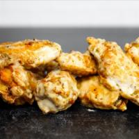 12 Classic Bone-In Wings · 12 Classic bone-in chicken wings tossed in sauce and served with homemade buttermilk ranch, ...