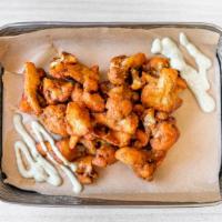 Cauliflower Buffalo Bites · Lightly battered and seasoned cauliflower tossed in Buffalo sauce served with a side of ranc...