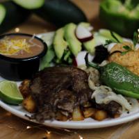 Carne Asada · Cooked Carne Asada . Alongside is a  jalapeños