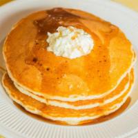 Buttermilk Pancakes · Three homemade pancakes served with maple syrup
