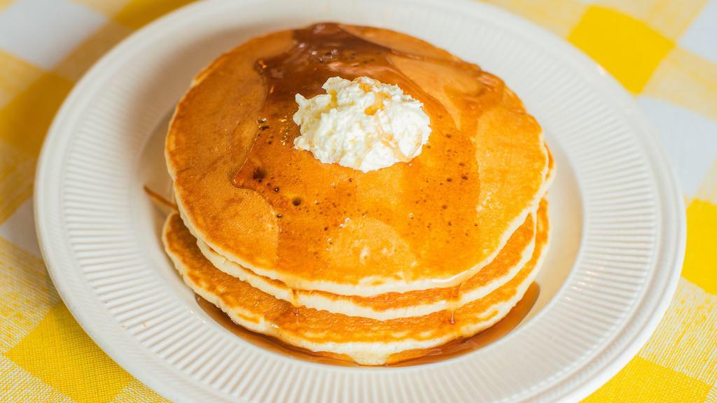 Pancakes · Three homemade pancakes served with maple syrup