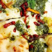 Pesto Pizza · Mozzarella, cherry tomatoes, pesto, fresh basil and Parmesan