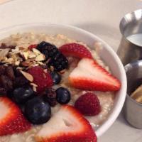 Katrina'S Oatmeal · Slow cooked buckeye rolled oats topped with raisins, almonds, and fruit served with milk and...