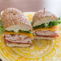 Turkey Melt · Cracked pepper turkey, melted cheddar cheese topped with romaine lettuce, plump tomato, red ...
