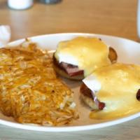 Eggs Benedict · Two poached eggs, piled high with grilled ham on an English muffin topped with hollandaise s...