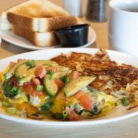 Chile Verde Omelette · Homemade chile Verde with jack cheese, topped with sour cream.