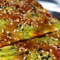 Avocado Toast · Squaw bread topped with avocado spread, greens and spices