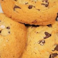 Chocolate Chip Cookies · three fresh baked chocolate chip cookies topped with sea salt