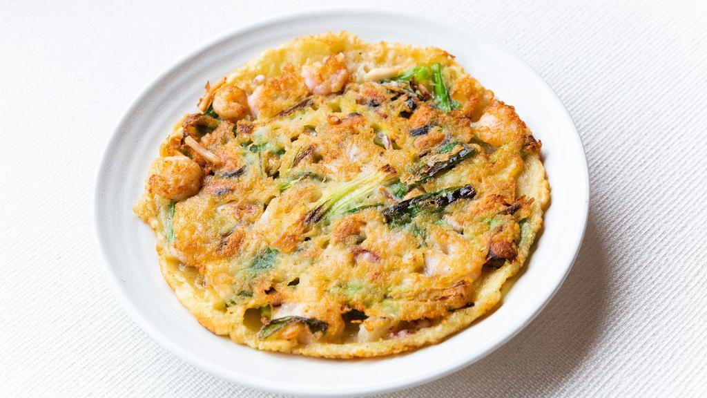 Seafood Pajeon · Korean style thin seafood pancake with squid, mussel, shrimp, and green onion.