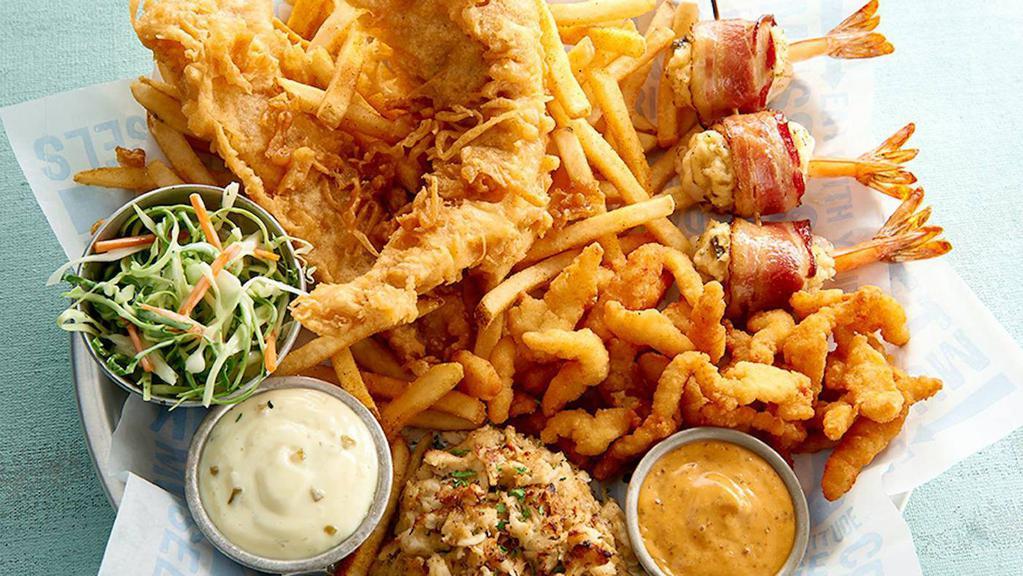 East Coast Platter · Seafood stuffed crab, bacon-wrapped shrimp filled with seafood stuffing, cheese and jalapeños, fried fish fillet, popcorn shrimp with fries and coleslaw