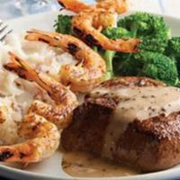Land And Sea · 8oz. USDA Choice Top Sirloin topped with garlic butter, grilled shrimp skewer. Served over m...
