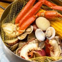 Cajun Steampot · Dungeness crab, cold water lobster claws, shrimp, mussels, smoked sausage, Ragin’ Cajun  sea...