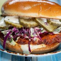 Buffalo Chicken Sandwich · country fried chicken breast tossed in buffalo sauce, slaw, lemon-herb mayo, pickles, brioch...