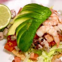 Shrimp Tostada · Fried tortilla, mayo, lettuce, onions, tomato, avocado, shrimp.