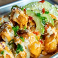 Southwest Tots · Tots loaded with cheese sauce, pickled peppers, jalapeños, chipotle aioli, avocado, cotija c...