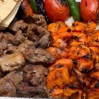 #25 Family Meal Pack - 3 Skewers Of Chicken Kabob And 2 Beef Shish Kabob · Feeds for 4-5, Served with Rice, Shirazi Salad, Hummus, Grilled Tomatoes and Peppers