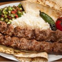 #12A Persian Koubideh Beef · Two Skewers Ground Sirloin Beef served with Rice, Pita Bread, Shirazi Salad, Grilled Tomatoe...