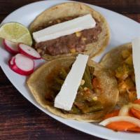 Taco Rajas · Vegetarian. Poblano peppers, corn, tomato and onion. Served with fresh cheese. For vegan opt...