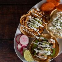 Volcan Tinga · Shredded chicken breast in a spicy chipotle sauce served on a crispy tortilla topped with me...