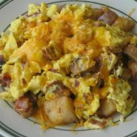 Country Skillet · Diced sausage, bacon, and 2 scrambled eggs, topped with cheddar cheese, atop home fries. ser...