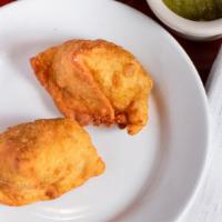 Samosa (2 Pieces) · Deep fried cone pastry stuffed with potatoes and green peas.