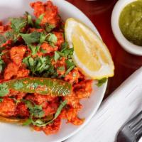 Chicken 65 · Marinated chicken deep fried in spices and curry leaves.