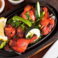 Tandoori Chicken (Ala Carte) · Chicken marinated in exotically spiced yogurt and roasted in a clay oven.