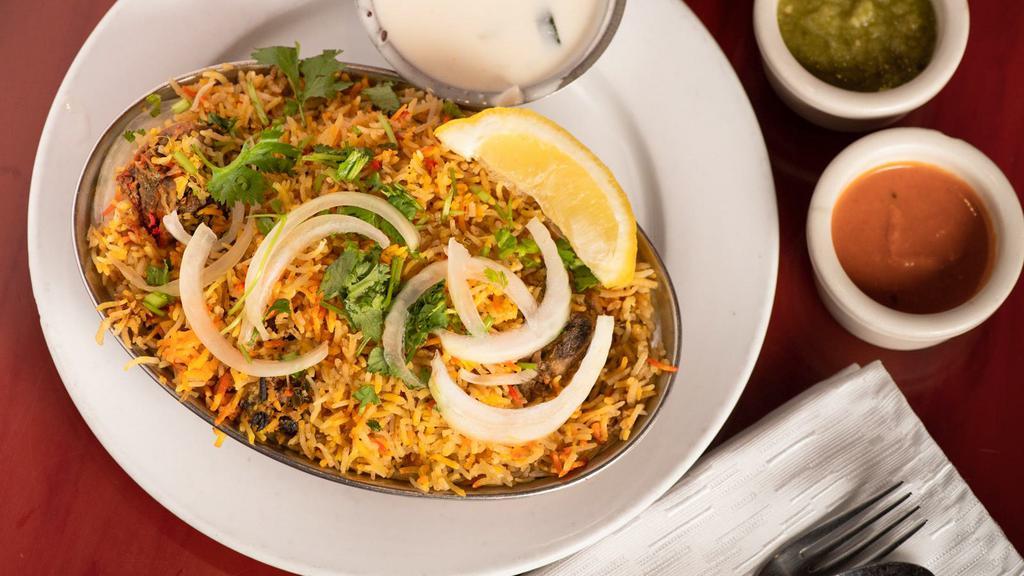 Chicken Biryani(Ala Carte) · Basmati rice and chicken flavored with saffron, cooked with Indian herbs on low heat. Ala carte served with raita.