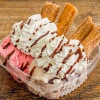 Churros With Ice Cream · Churros with two flavors of ice cream, topped with whip cream, syrup, and topping.
