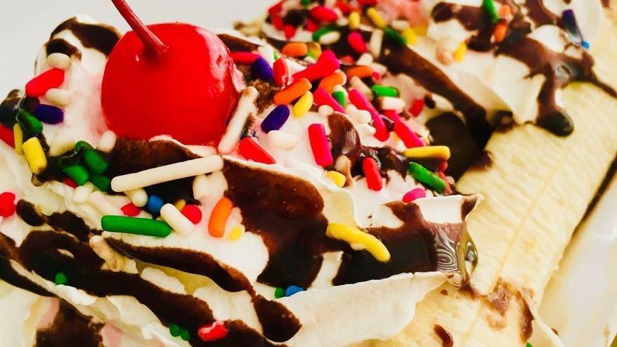 Banana Split · Pick any three flavor of ice cream, served with a banana split in 1/2 topped with whip cream, syrup of choice, topping of choice and cherries.