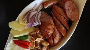Sai Kork Esan - North East Thai Sausage · Pork sausage with cabbage, chili, peanuts, and ginger.