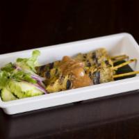Moo Ping - Bbq Pork Skewers · Coconut, garlic marinated pork skewers grilled and served with sweet chili sauce.