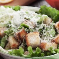 Caesar Salad · Romaine lettuce tossed with creamy Caesar dressing topped with croutons and fresh graded par...