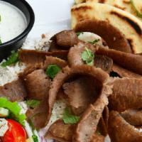 Gyros Plate · Thinly sliced beef and lamb cooked on a vertical rotisserie served on a bed of rice with pit...