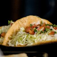 Fish Taco · Grilled basa fillet, cabbage, salsa Mexicana, and Lolita's salsa blanca on a soft corn torti...
