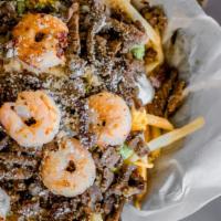 Tsunami Fries (Large) · Carne asada, grilled shrimp, guacamole, sour cream, cheddar and cotija cheese.