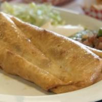 Chimichanga · Deep-fried burrito filled with meat, bean, rice and cheese, then topped with salsa, guacamol...