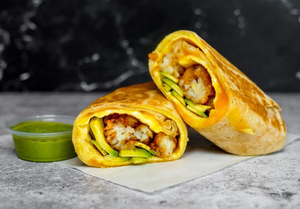Avocado, Egg, & Cheddar Breakfast Burrito · 3 fresh cracked, cage-free scrambled eggs, melted Cheddar cheese, avocado salsa verde, fresh avocado, and crispy potato tots wrapped in a toasted 12” flour tortilla. Comes with avocado salsa verde side