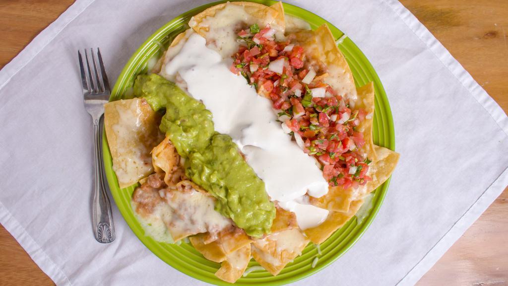 Super Nachos · Your choice of meat, beans, sour cream, guacamole, melted cheese, and pico de gallo salsa. Served on top of fresh crispy corn tortilla chips.